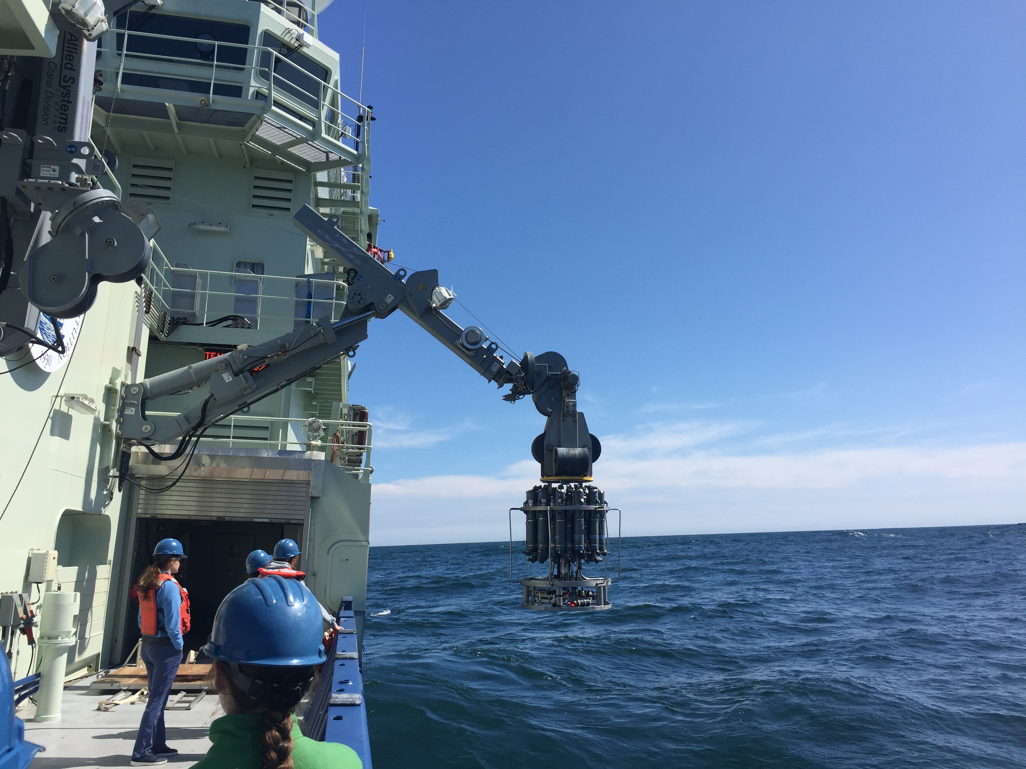 An oceanographic instrument package being deployed from a research vessel